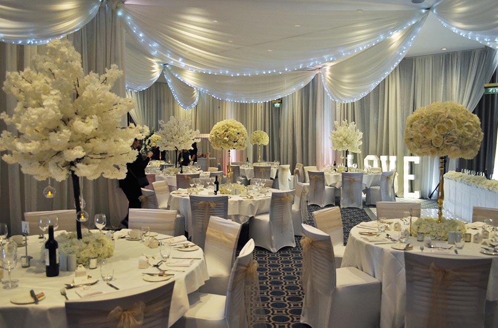 Wall and Ceiling drapes with white fairy lights, Uplighting and illuminated LOVE letters for a wedding breakfast at Alexandra House Conference centre Swindon