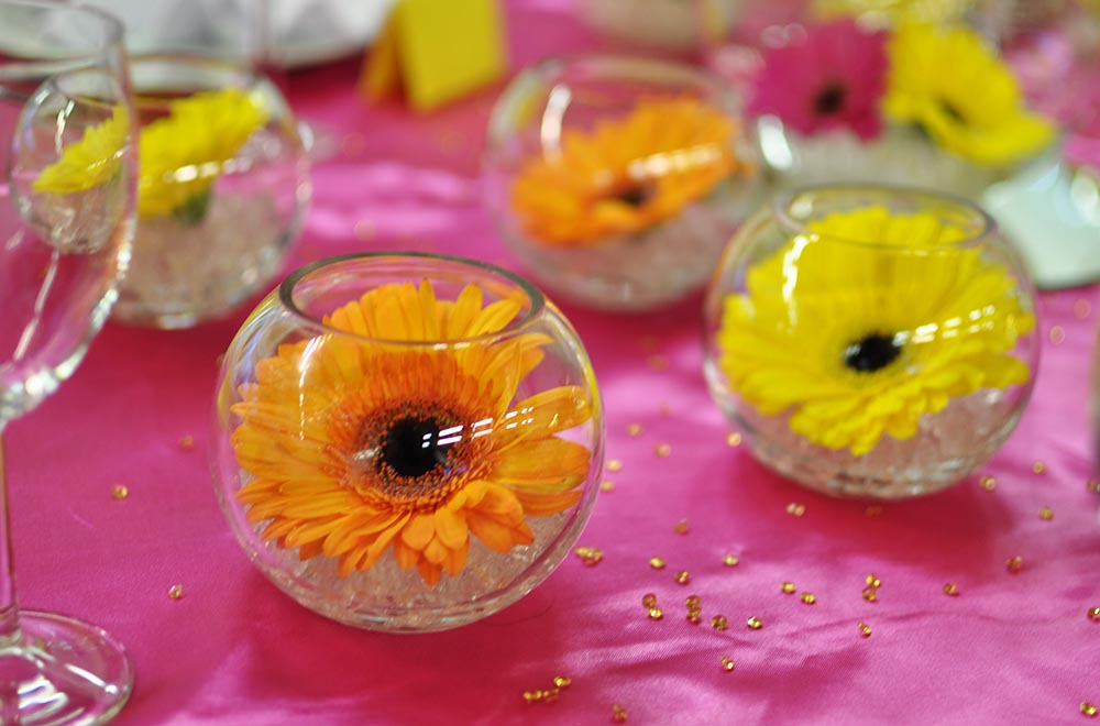 minature fishbowls with flower head wedding centrepiece