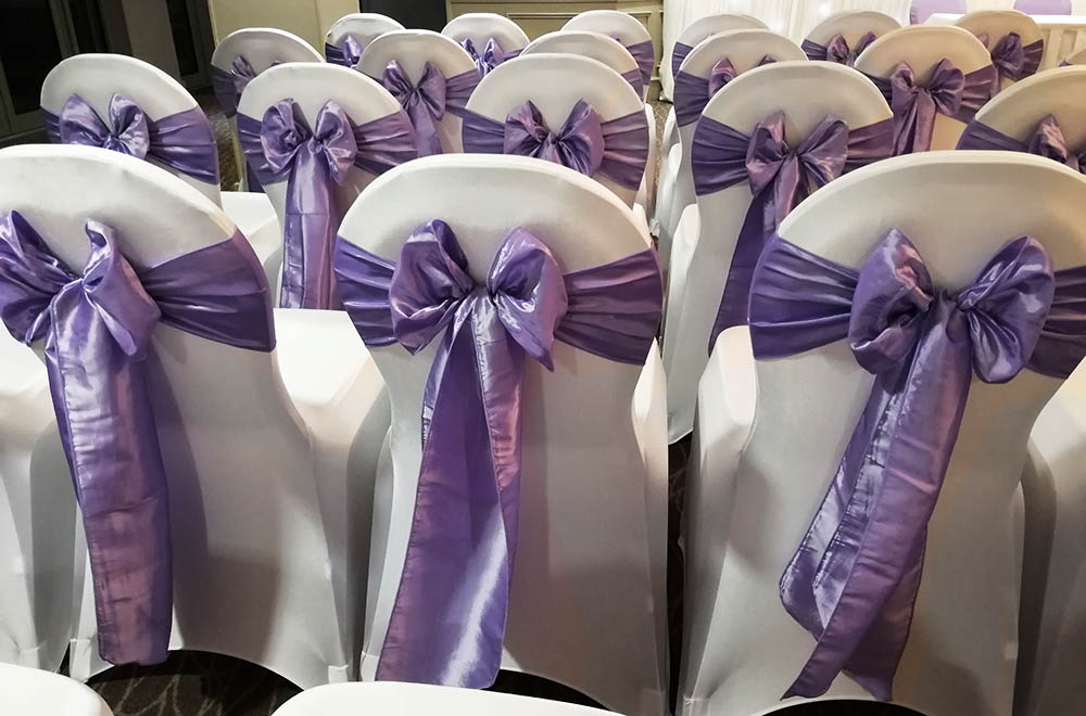Chair Covers with purple Taffeta Sash Bows for a wedding in Swindon
