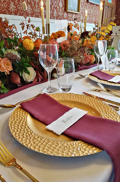 Autumnal themed wedding breakfast table, with gold charger plates