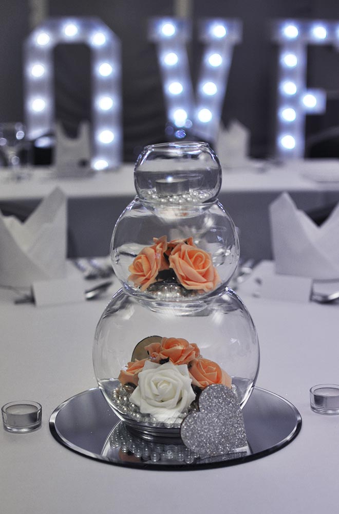 3 Three tier wedding fishbowl centrepiece on mirror plate and artificial flower heads and pearls