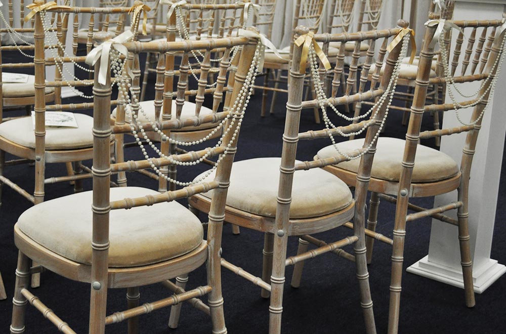 Wedding bead garland on chivari chairs ar De Vere cotswold waterpark wedding ceremony