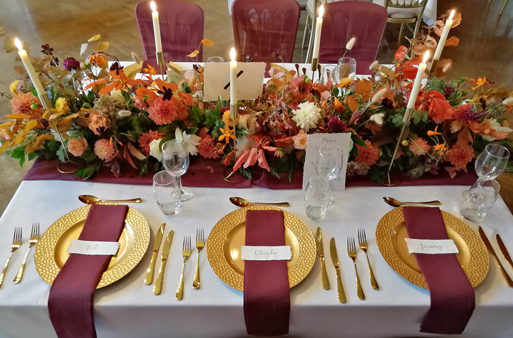 Decorated wedding table with gold charger plates at Grittleton House