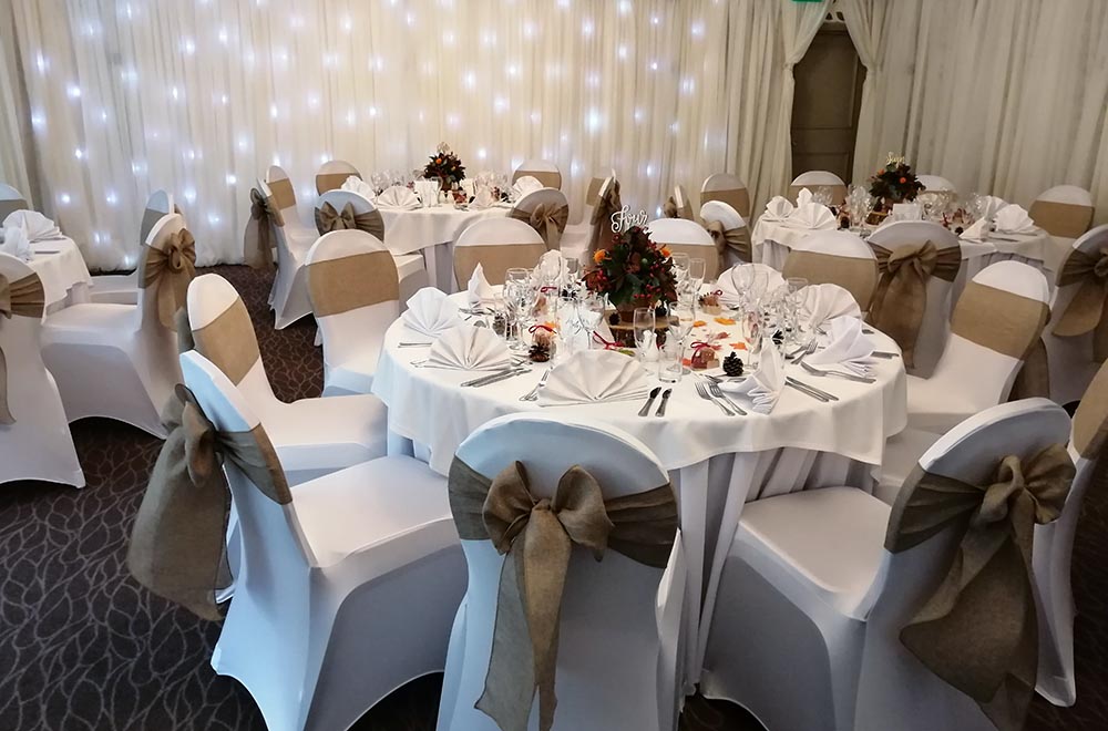 Cotton hessian chair cover sashes at the Crown of Crucis wedding in Cirencester, Cotswolds