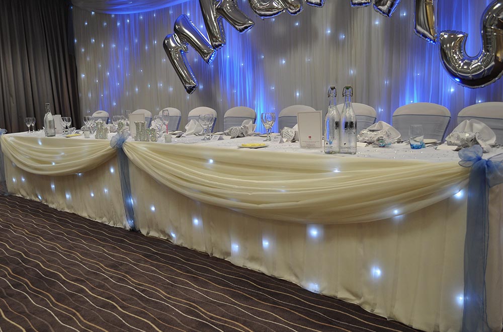 Starlit top table skirt and backdrop at De Vere Cotswold Waterpark Hotel