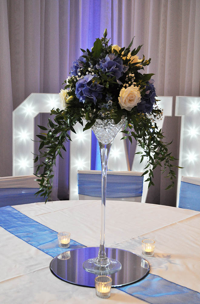 martini Glass wedding centrepiece with mirror plate and LED gel balls and floral arrangement
