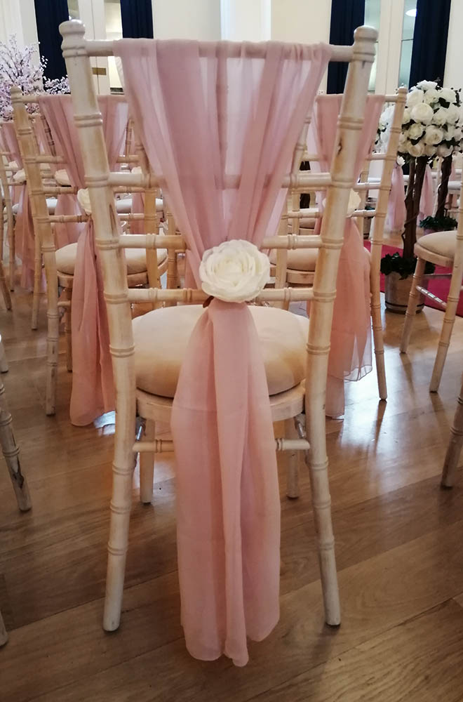 Pink chiffon chair drops with Ivory White flower head embellishment