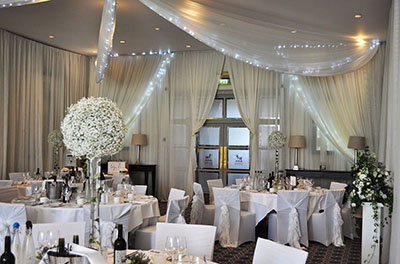 White wedding, with room and ceiling drapery, at Bowood House Hotel and Golf Club