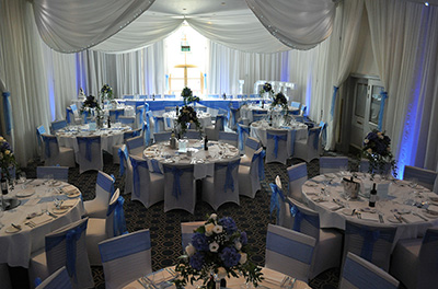 Wedding breakfast at Bowood House Hotel and Golf Club, setup with royal blue organza