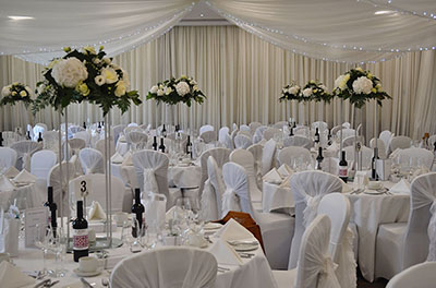 All white wedding, with ruffle hoods and room drapery, at the Cotswold Water Park Hotel (De Vere)