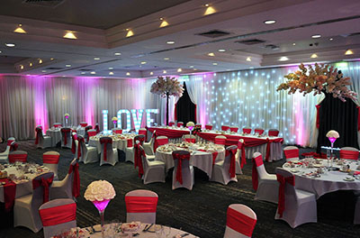 Hot pink satin wedding at DoubleTree by Hilton, Swindon, with room drapery and our giant canopy blossom trees