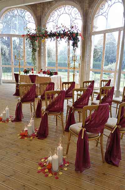 Aisle styling for a burgundy wedding at Grittleton House