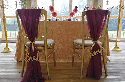 Personalised Bride and Groom chair ties during a ceremony in the Orangery at Grittleton House