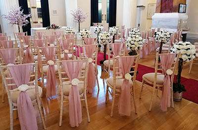 Light pink chiffon chair drops, with additional floral detail, at Pittville Pump Rooms