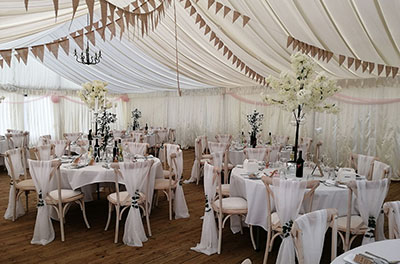 Wedding breakfast at Stanton Manor, with blossom tree and candelabra centrepieces