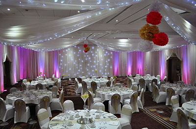 Full room and ceiling drapery, with champagne organza sashes, at Swindon Marriott Hotel