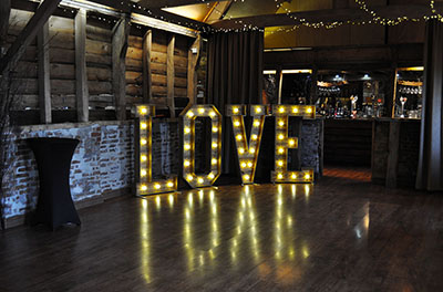 Our rustic LOVE letters, edging the dancefloor, at Wellington Barn