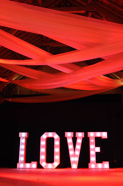 LOVE letters and red mood lighting at Wick Bottom Barn