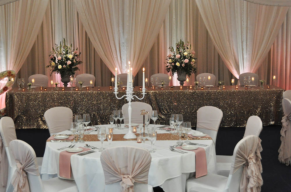 Rose Gold Sparkle sequin table runner covering with candles for a wedding at De Vere Cotswold Waterpark Hotel
