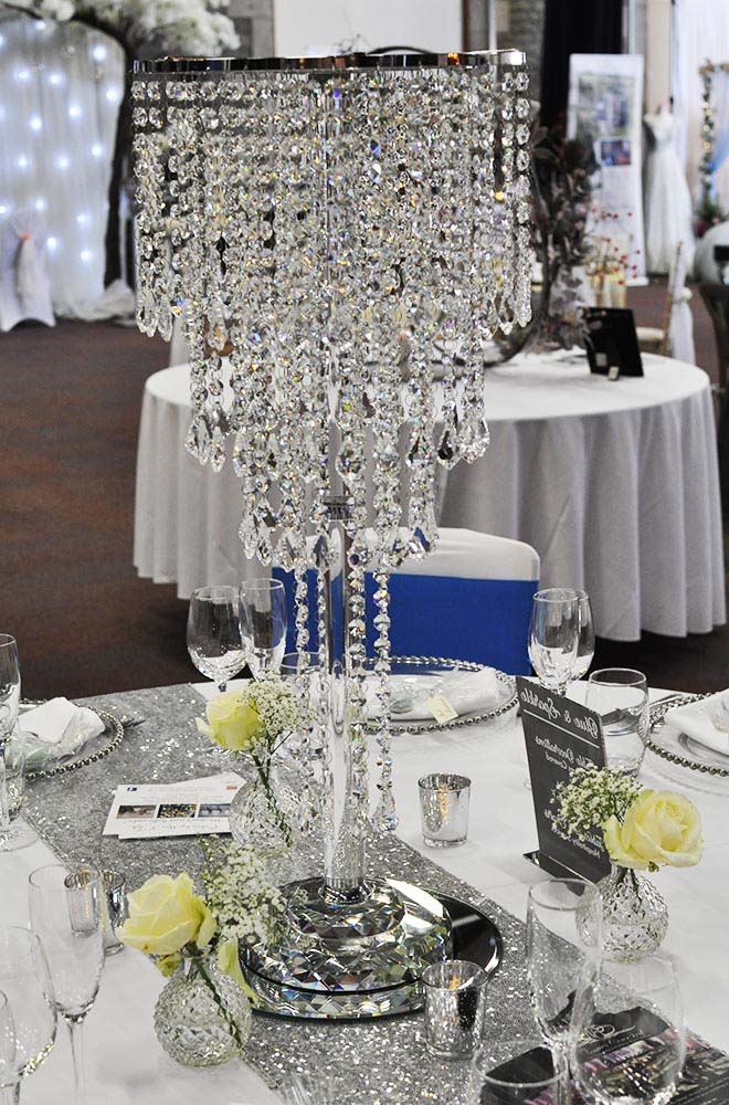 Wedding centrepiece table crystal chandelier on a mirroreed plate