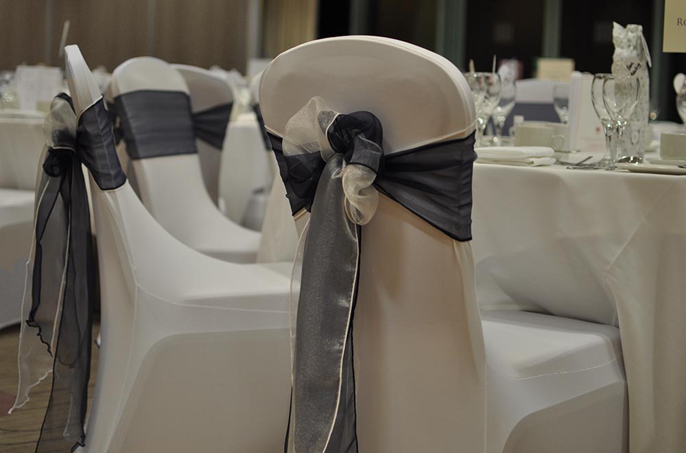 De Vere wedding at Cotswold Watwater Park Hotel with chair covers and blue double organza sash