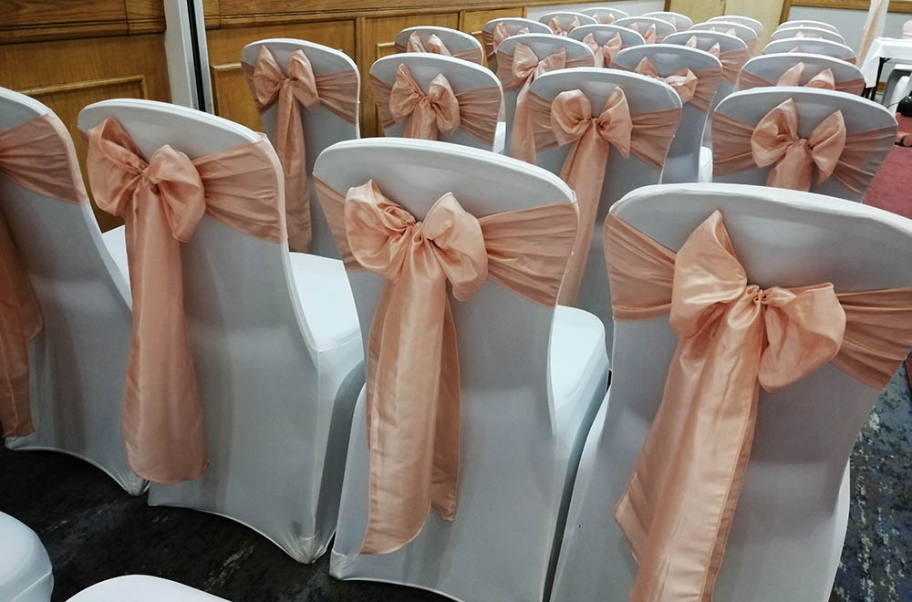 Peach and Blush Pink taffeta chair sashes for a wedding ceremony at Doubletree Hilton Hotel Swindon