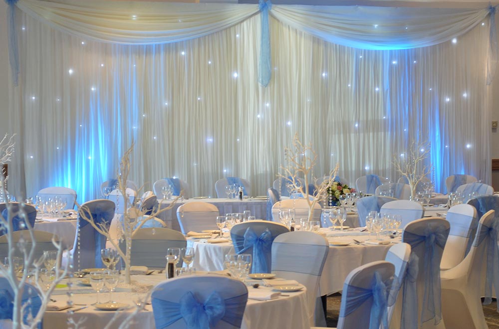 White starlit LED backdrop with blue uplighting at Hilton Hotel Wedding, Swindon