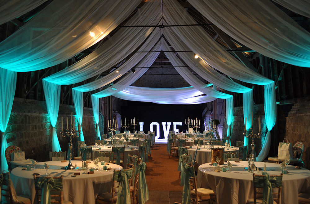 Wick Bottom Barn sail ceiling and wall voile drapes wedding drapery with uplighting and LOVE letters
